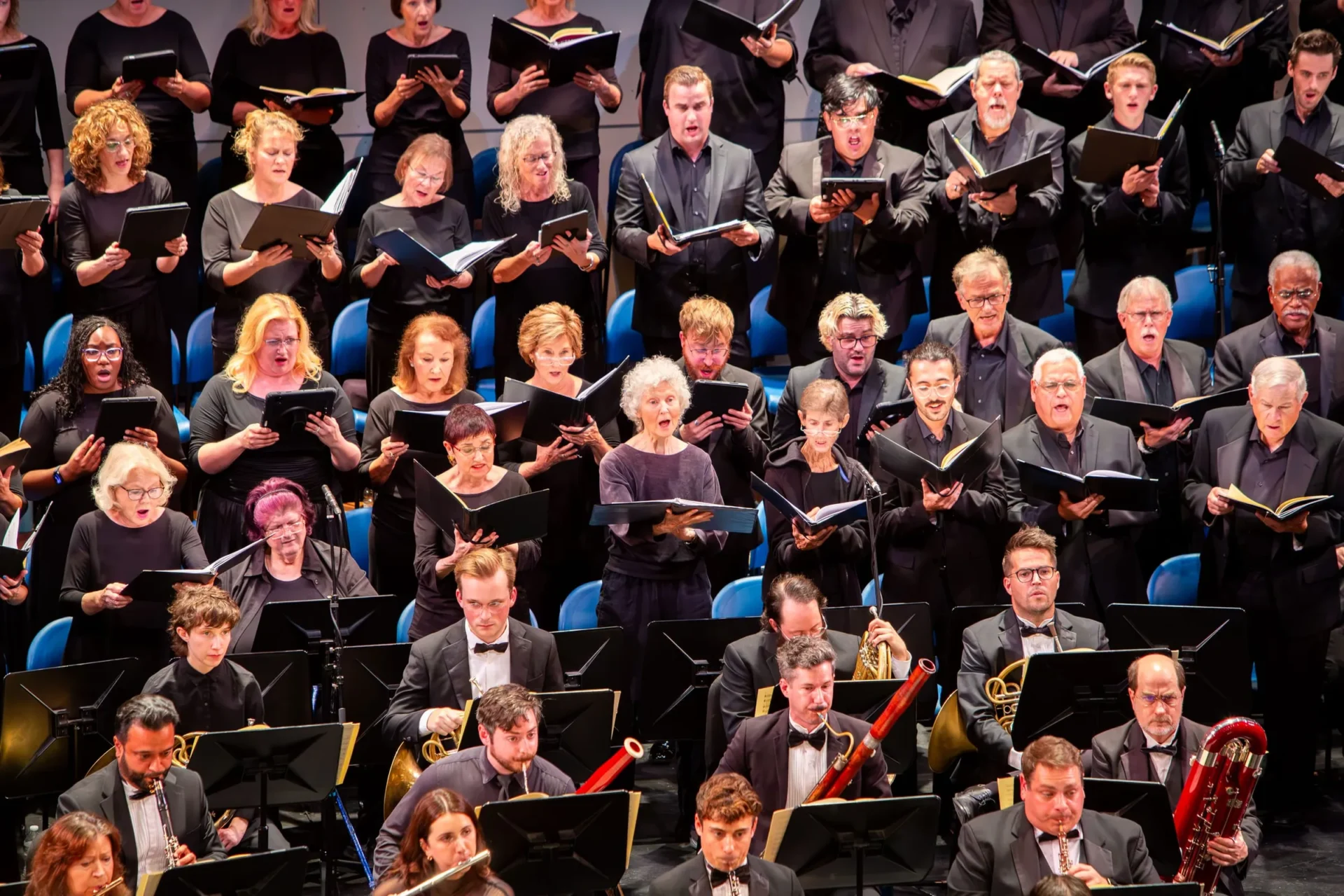 Key Chorale performing with a full mixed chorus and orchestra onstage.